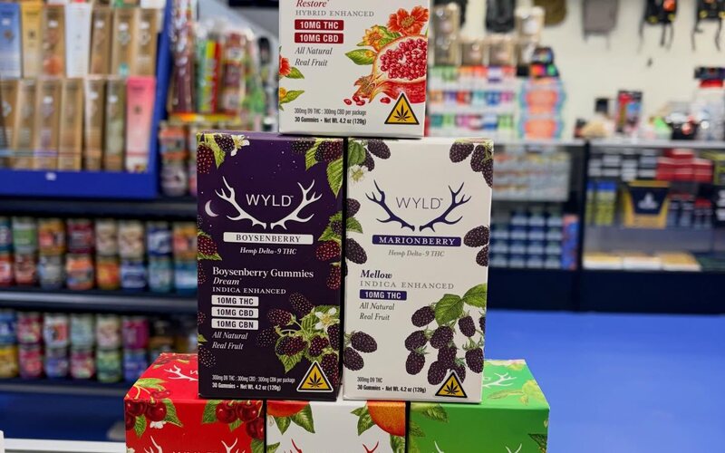 Wyld hemp gummies boxes stacked on the blue floor.